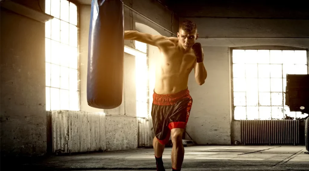 Young-Boxer-Punching-Heavy-Bag-In-Boxing-Gym-1